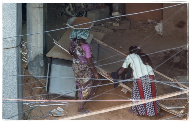 Women sieving and carrying sand
